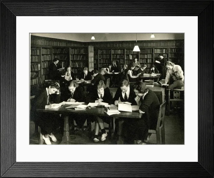 Framed Print : Schoolgirls in uniform studying in a library Framed Print : Schoolgirls in uniform studying in a library