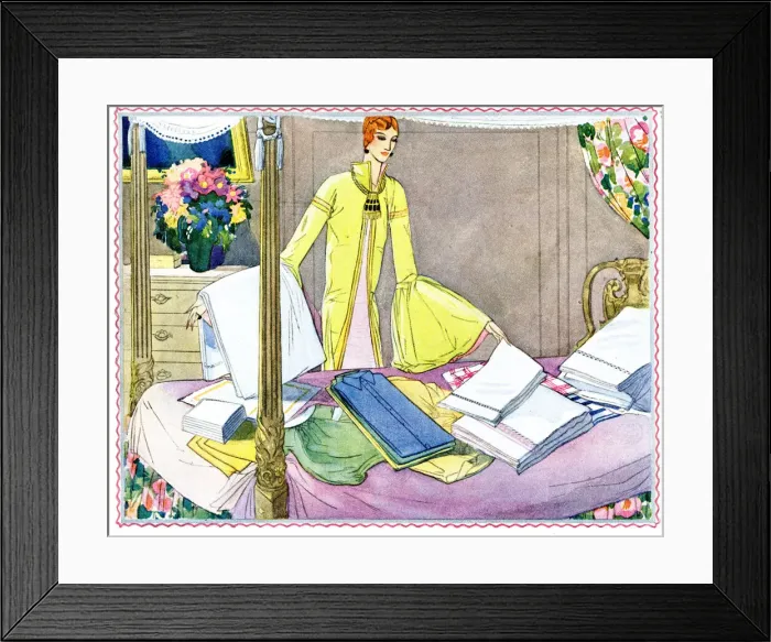 Framed Print : Woman sorting out laundry on four poster bed Framed Print : Woman sorting out laundry on four poster bed