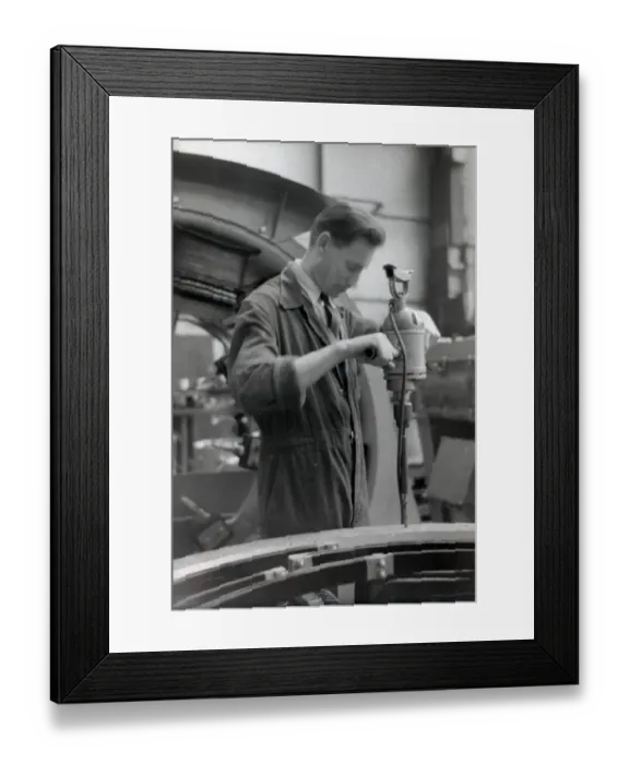 Framed Print : An engineer in overalls working with a large hand drill Framed Print : An engineer in overalls working with a large hand drill
