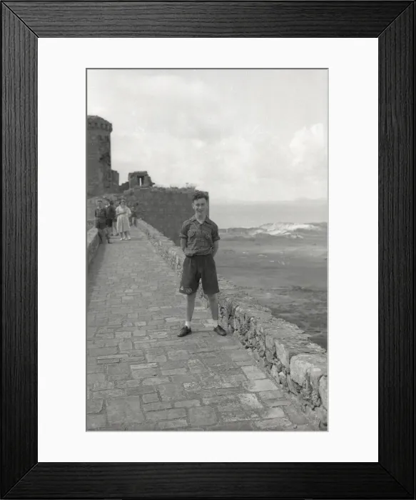 Framed Print : Young boy standing on the ramparts of Harlech Castle Framed Print : Young boy standing on the ramparts of Harlech Castle