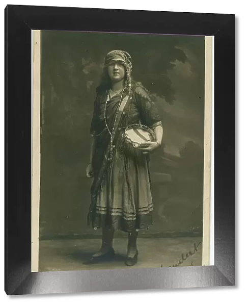 A young woman in fancy dress, in a type of Romany gipsy costume that was very popular in