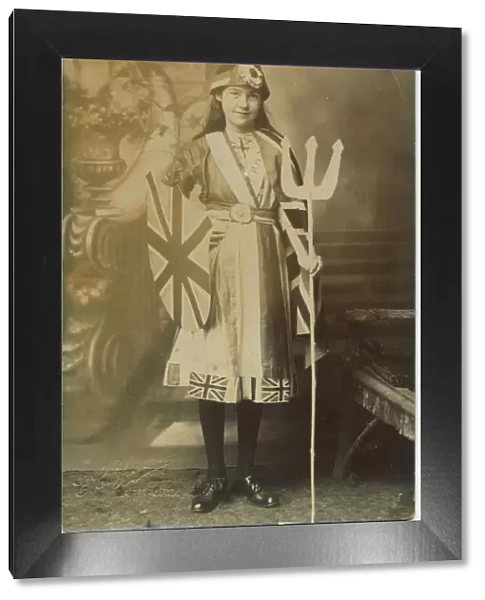 A young girl in a fabulously patriotic fancy dress costume as Britannia. Date: 1910s