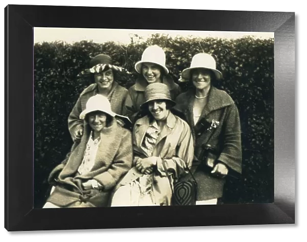 A group of five women posing for a photograph in the 1920s, all in hats