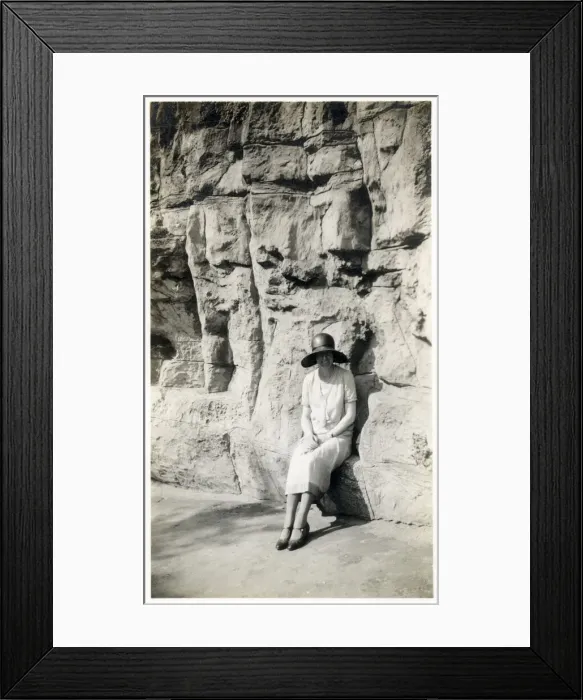 Framed Print : Lady sitting on a natural seat beneath a rock cliff Framed Print : Lady sitting on a natural seat beneath a rock cliff