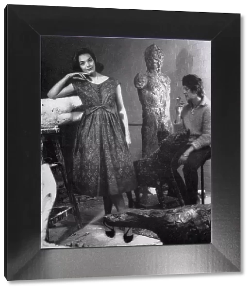 Model wearing a cotton dress by Sambo, visits Elisabeth Frink, the sculptor in her studio