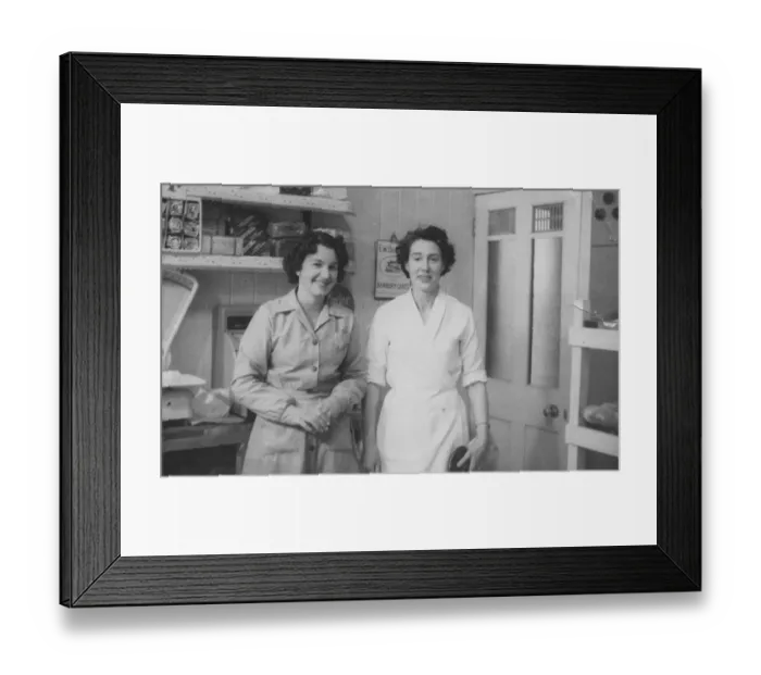 Framed Print : Two women pose for their photograph in a bakers shop. Date: c. 1953 Framed Print : Two women pose for their photograph in a bakers shop. Date: c. 1953