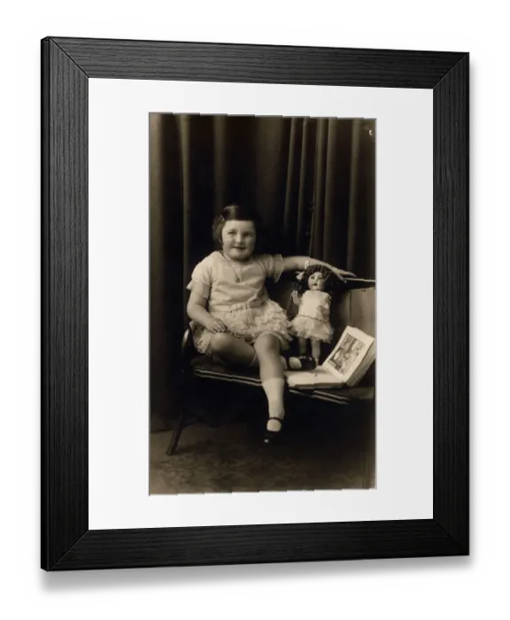 Framed Print : Studio photograph of a little girl pictured with a doll and picture book Framed Print : Studio photograph of a little girl pictured with a doll and picture book
