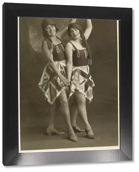 Two women pose for a photograph in identical fancy dress costumes