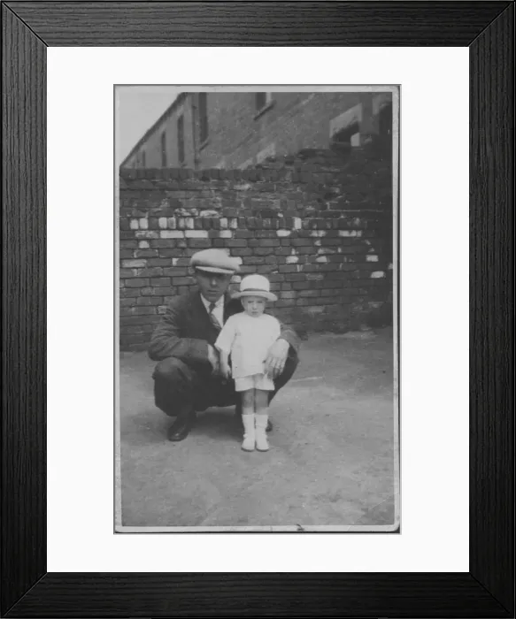 Framed Print : A father poses with his little boy in a back street. Date: 1920s Framed Print : A father poses with his little boy in a back street. Date: 1920s