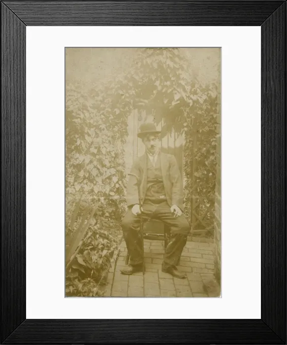 Framed Print : A person sitting in a back yard dressed up as Charlie Chaplin. Date: c. 1918 Framed Print : A person sitting in a back yard dressed up as Charlie Chaplin. Date: c. 1918