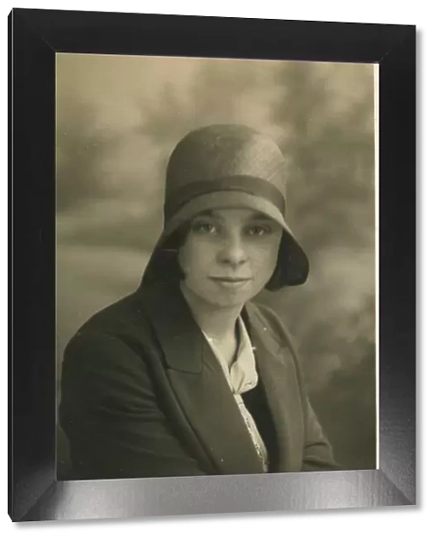 A young woman, called Lily Hughes, photographed in a cloche hat. Date: c. 1928