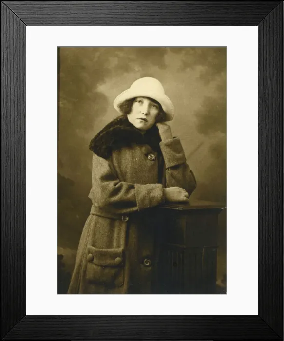 Framed Print : A rather morose looking young woman poses for a studio photograph. Date: c. 1923 Framed Print : A rather morose looking young woman poses for a studio photograph. Date: c. 1923