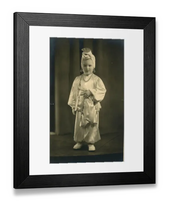 Framed Print : A small boy (or girl) dressed in a turban and harem pants in an Arabian Nights style