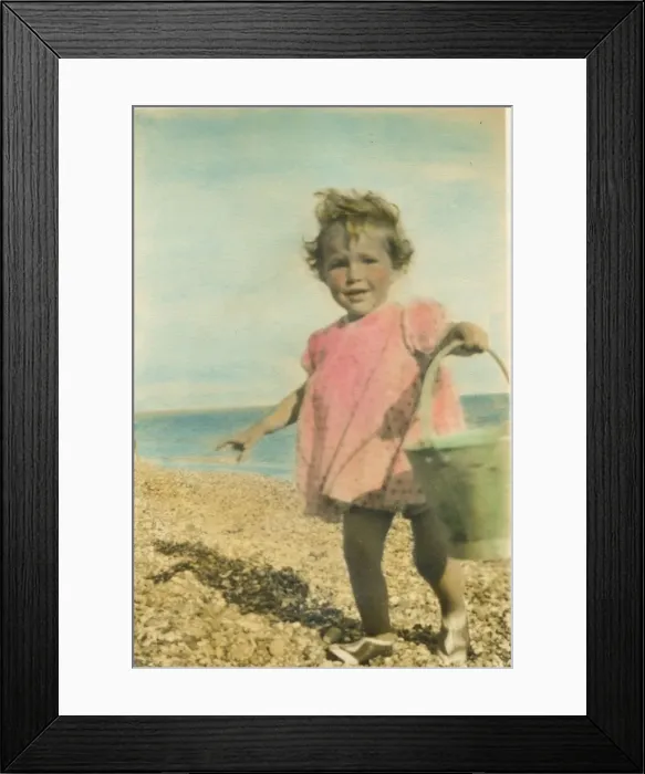 Framed Print : A toddler on the beach at Bognor Regis with a bucket in hand. Date: 1920s Framed Print : A toddler on the beach at Bognor Regis with a bucket in hand. Date: 1920s