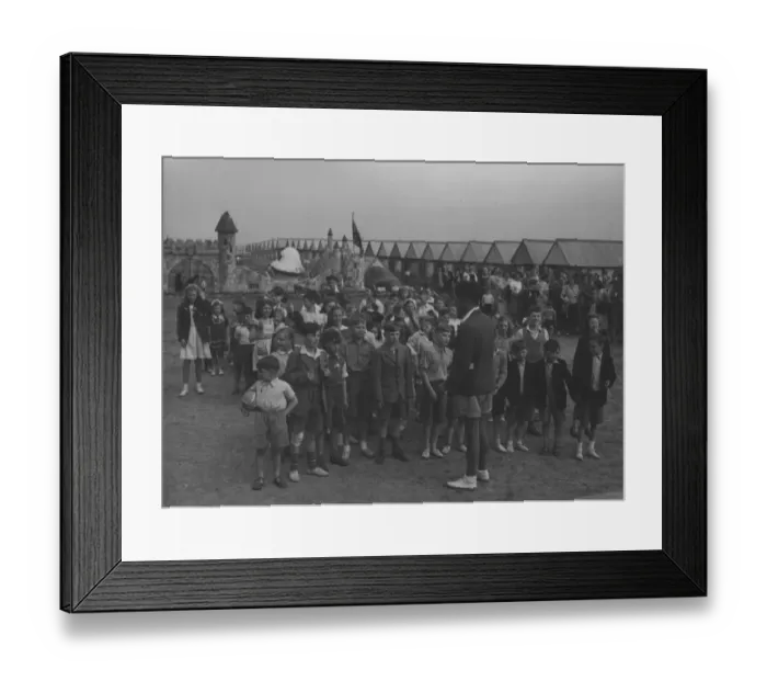 Framed Print : A large group of children at Butlins are entertained by a single male Redcoat Framed Print : A large group of children at Butlins are entertained by a single male Redcoat