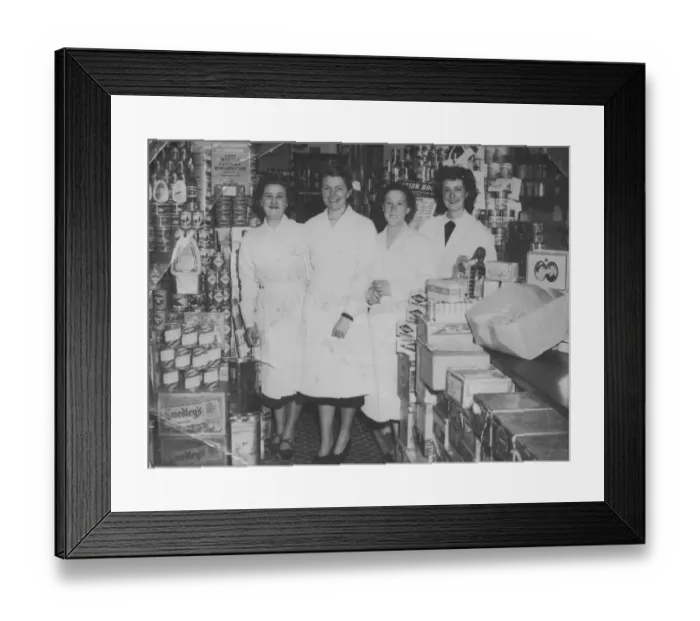 Framed Print : Four shop workers line up for a photograph in a well-stocked grocery store Framed Print : Four shop workers line up for a photograph in a well-stocked grocery store