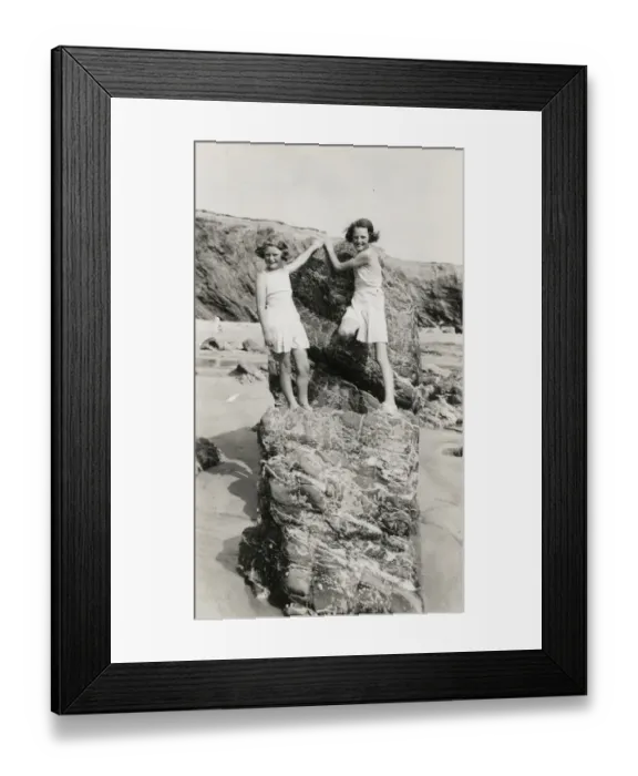 Framed Print : Two young girls playing on the rocks on a Cornish beach Framed Print : Two young girls playing on the rocks on a Cornish beach