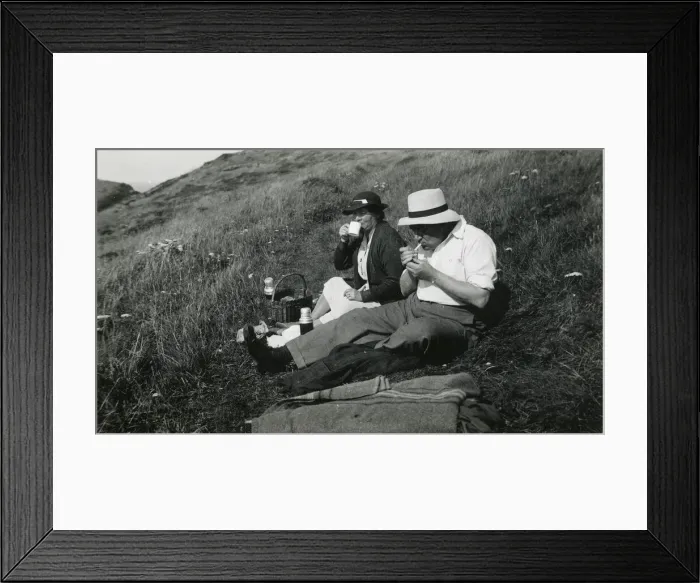 Framed Print : A late middle-aged couple enjoying a picnic Framed Print : A late middle-aged couple enjoying a picnic