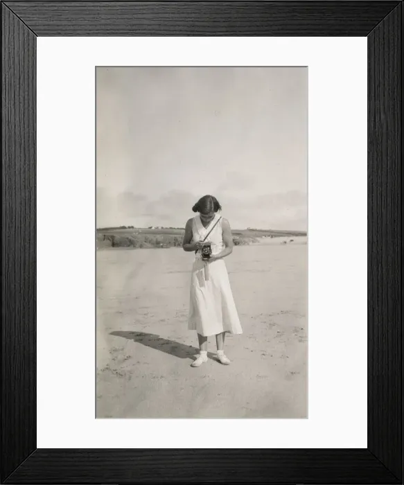 Framed Print : Woman taking a photograph on the beach Framed Print : Woman taking a photograph on the beach