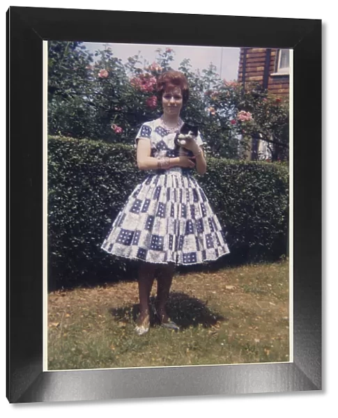 Young lady in smart summer frock - suburban garden