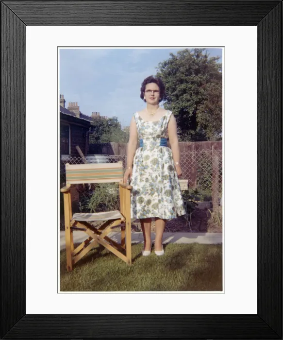 Framed Print : Woman in a neat suburban garden with garden chair Framed Print : Woman in a neat suburban garden with garden chair