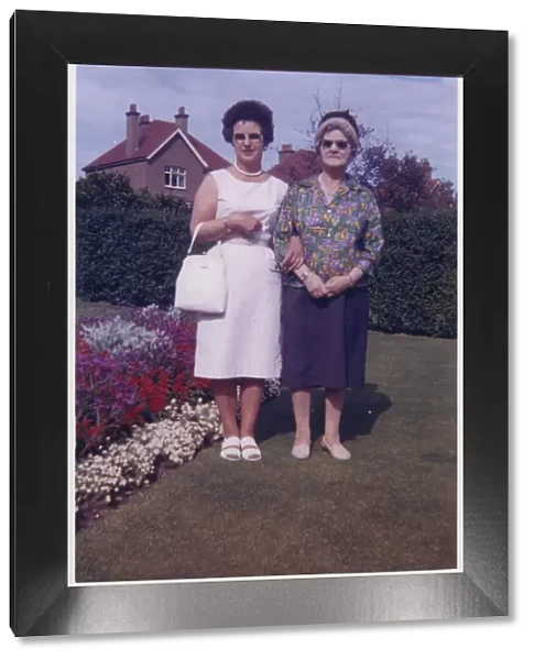 Mother and Grandmother in a neat suburban back garden