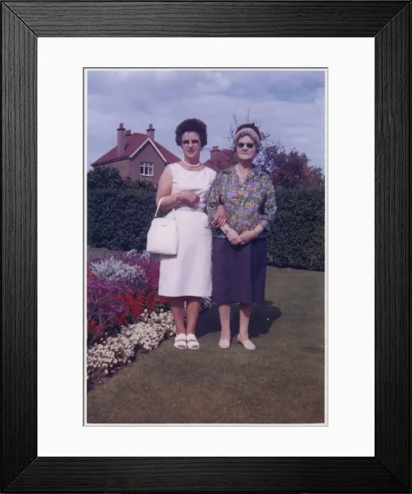 Framed Print : Mother and Grandmother in a neat suburban back garden Framed Print : Mother and Grandmother in a neat suburban back garden
