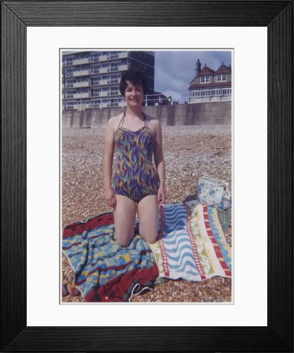Framed Print : Young lady on the beach in swimsuit - colourful beach towel Framed Print : Young lady on the beach in swimsuit - colourful beach towel