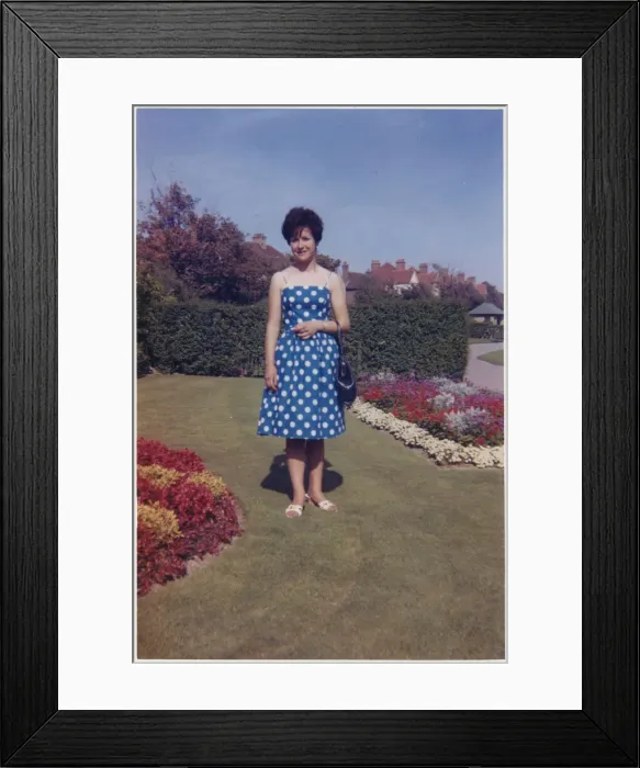 Framed Print : Young lady standing between beautifully-manicured flowerbeds Framed Print : Young lady standing between beautifully-manicured flowerbeds