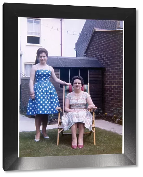 Mother and daughter in a neat suburban back garden - summer
