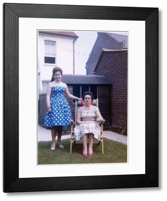 Framed Print : Mother and daughter in a neat suburban back garden - summer