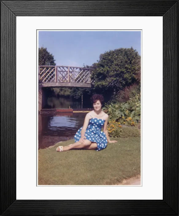 Framed Print : Pretty Young lady in a blue and white dress in a public park Framed Print : Pretty Young lady in a blue and white dress in a public park
