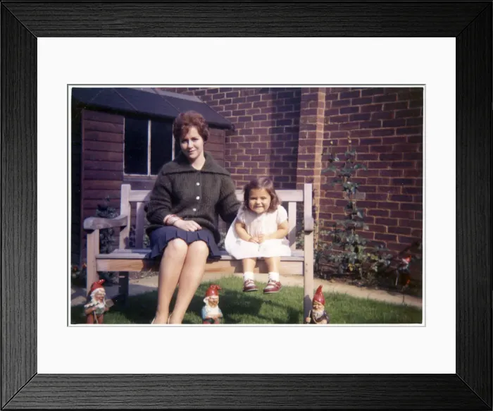 Framed Print : Young woman and her young niece on arden bench with gnomes Framed Print : Young woman and her young niece on arden bench with gnomes