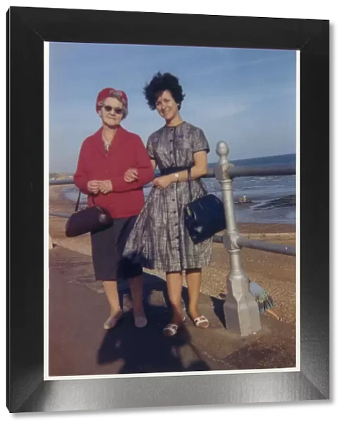 Young woman and her Grandmother take a stroll along seafront