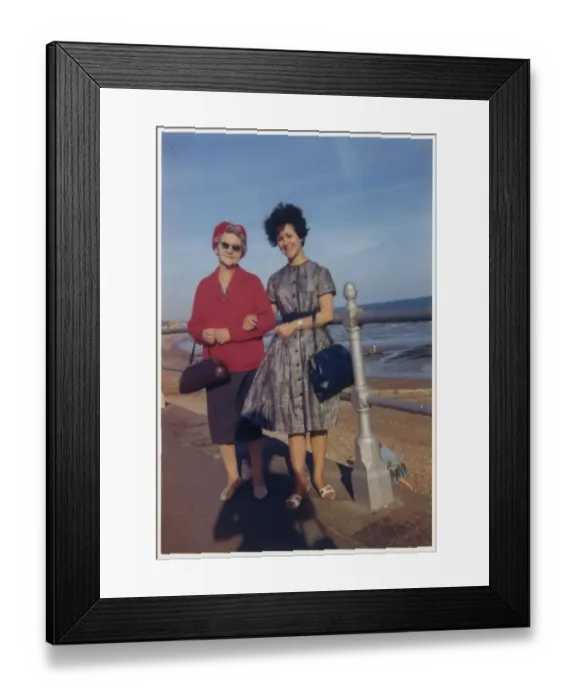 Framed Print : Young woman and her Grandmother take a stroll along seafront Framed Print : Young woman and her Grandmother take a stroll along seafront
