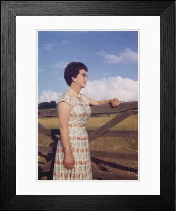 Framed Print : Smartly-dressed middle aged woman leaning on a gate Framed Print : Smartly-dressed middle aged woman leaning on a gate