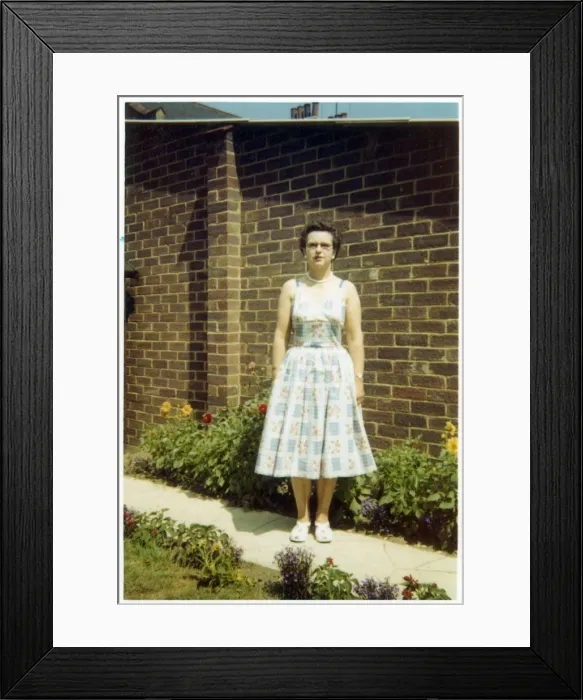 Framed Print : Middle aged woman on a path in a suburban British garden Framed Print : Middle aged woman on a path in a suburban British garden