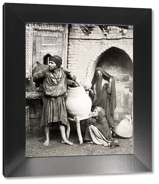 Porter, water carrier, woman, child in Cairo Egypt
