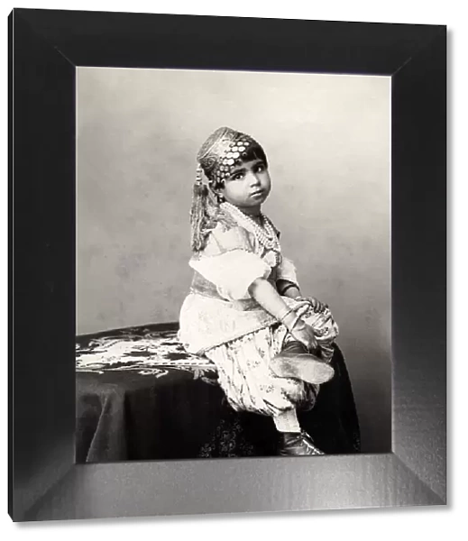 Cute child, photographers studio, probably India, late 19th