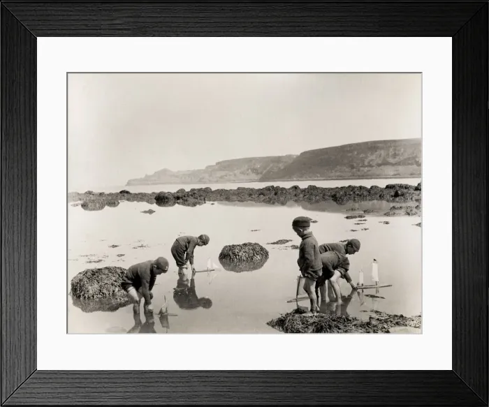 Framed Print : Children sailing boats in the sea, Runswick Baay Yorkshire Framed Print : Children sailing boats in the sea, Runswick Baay Yorkshire