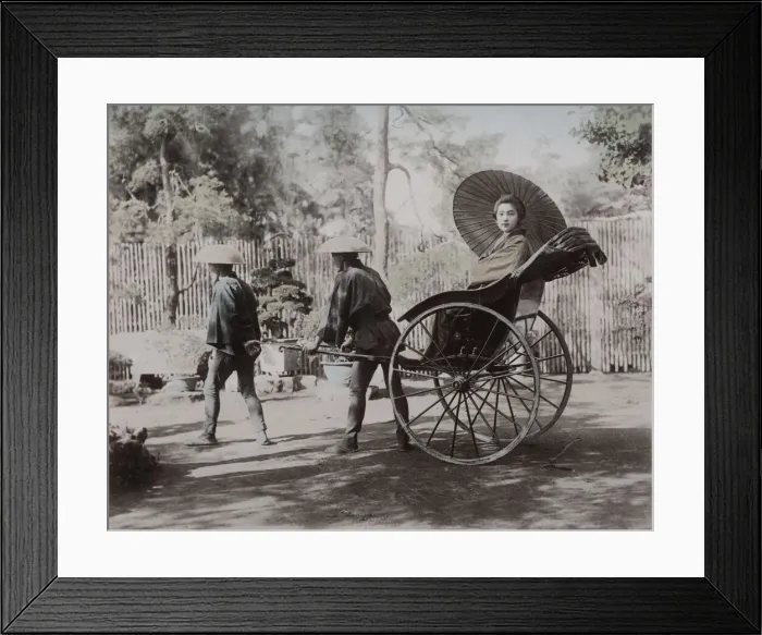 Framed Print : Young woman being pulled in a rickshaw, Japan Framed Print : Young woman being pulled in a rickshaw, Japan