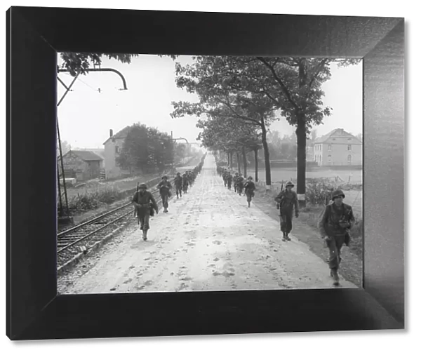 WW II 1st US Army marching on the road to Aachen, Germany