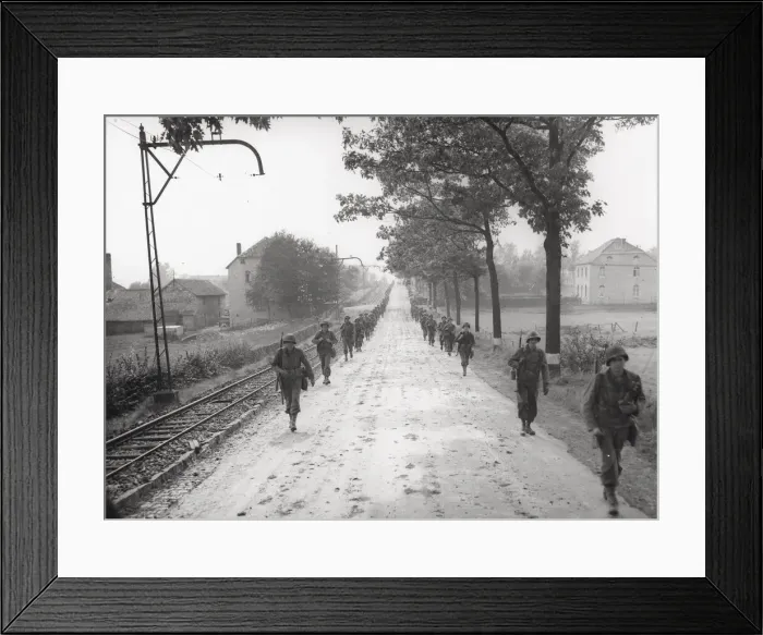 Framed Print : WW II 1st US Army marching on the road to Aachen, Germany Framed Print : WW II 1st US Army marching on the road to Aachen, Germany