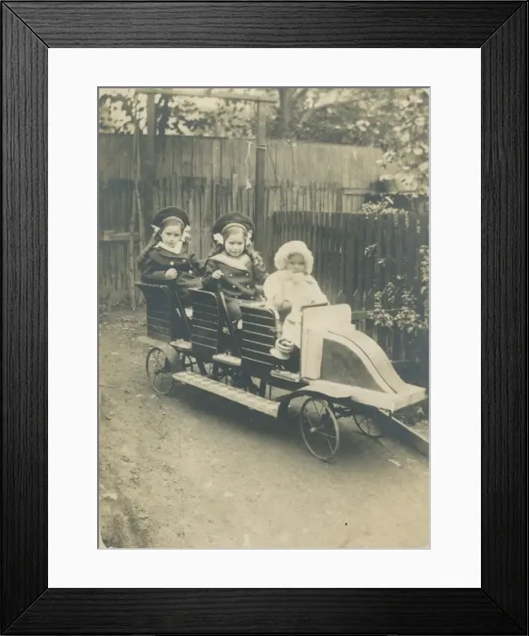 Framed Print : Three children in a very impressive toy car. We can only hope the baby at the front isn t Framed Print : Three children in a very impressive toy car. We can only hope the baby at the front isn t