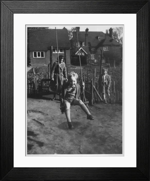 Framed Print : A little boy beaming widely as he gets a push on a garden swing Framed Print : A little boy beaming widely as he gets a push on a garden swing