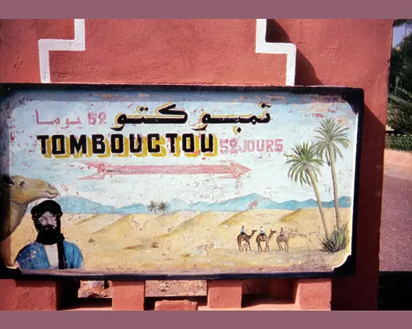A hand-painted sign showing the time it would take to reach Timbuktu in Mali (52 days