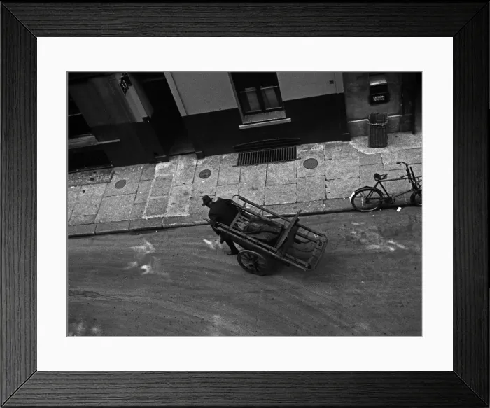 Framed Print : A man pulls a barrow in Marshall Street, London Framed Print : A man pulls a barrow in Marshall Street, London