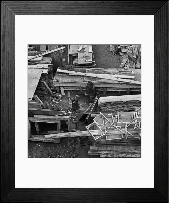 Framed Print : A man warms himself by brazier in woodyard Framed Print : A man warms himself by brazier in woodyard