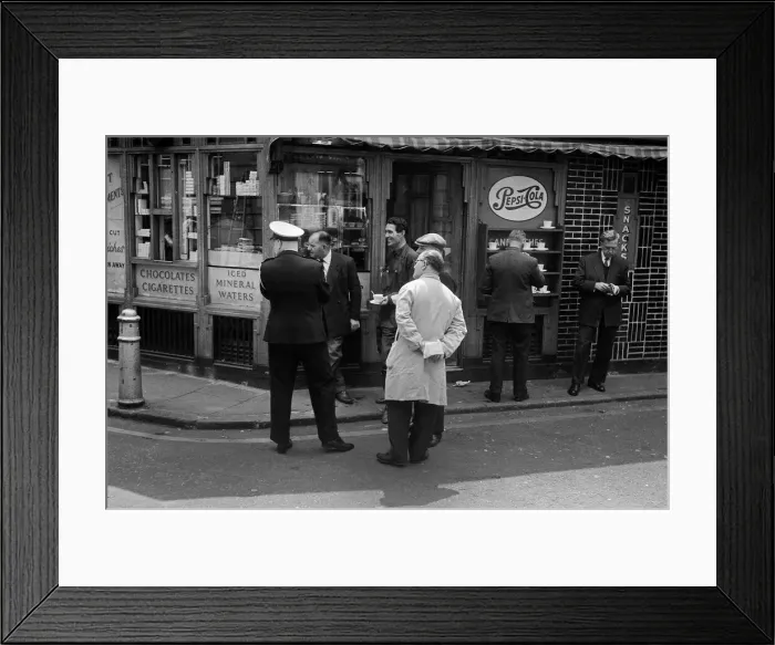 Framed Print : Men outside a snack bar see something amusing Framed Print : Men outside a snack bar see something amusing