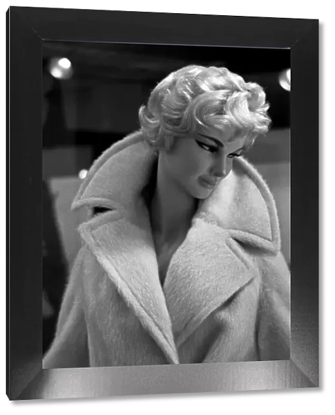 Mannequin modelling coat in window display, London